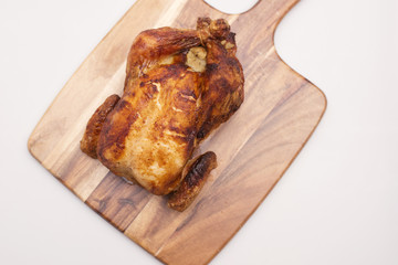 Oven roasted hot chicken on a white background.