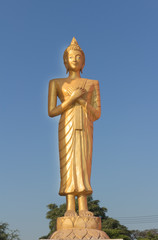 Golden Buddha standing and touching the chest