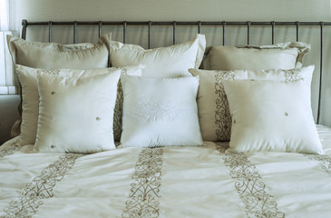 white and brown pillow on bed