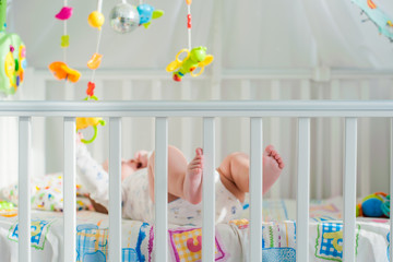 baby playing in a crib