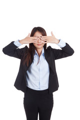 Young Asian businesswoman close her eyes with both  hands