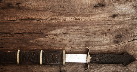 Broad sword on wooden background
