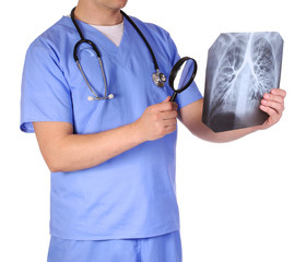 Doctor with stethoscope and magnifying glass examining x-ray