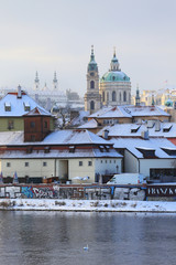 Obraz premium Romantic snowy Prague St. Nicholas' Cathedral, Czech Republic
