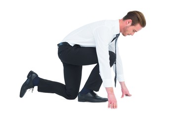 Businessman with hands and one knee on the floor