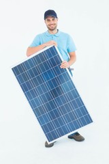 Smiling construction worker holding solar panel