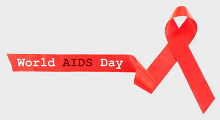 Red AIDS ribbon on light background
