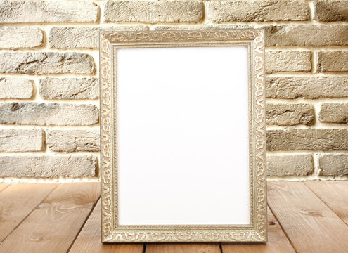 Photo frame on wooden table on wall background