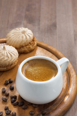 cup of espresso and cookies on wooden tray, vertical