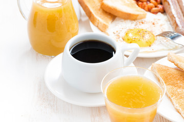 traditional breakfast - coffee, juice, eggs, toasts on table