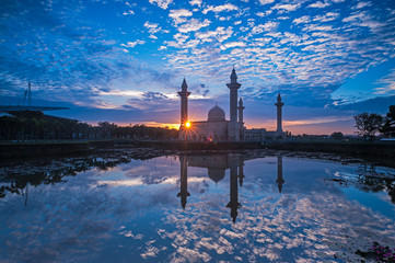 Relfection of a Mosque and Clouds at sunrise
