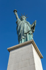 Obraz premium Paris, the Statue of Liberty on an island on the River Seine on