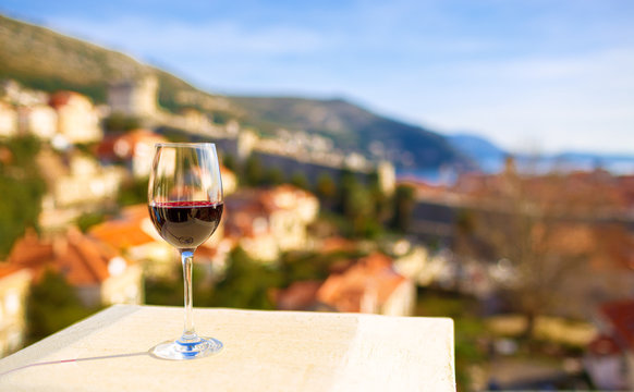 Glass of red wine with city view of Dubrovnik. Croatia.