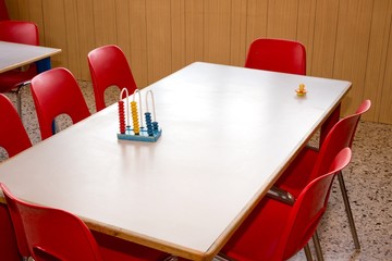 nursery with red chairs and desks for children