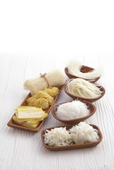 chinese dry noodle in wooden dish on white background