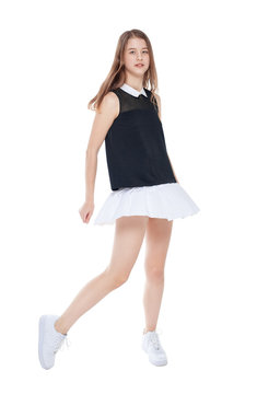 Young fashion girl in white skirt posing isolated