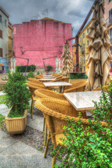 Fototapeta na wymiar tables and chairs in a small italian square