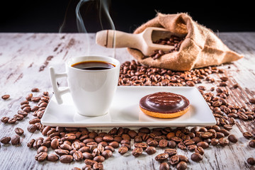 Hot coffee in the cup with the cookie