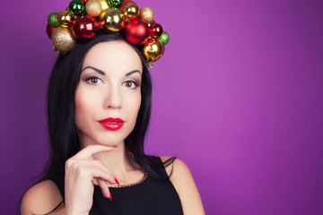 beautiful woman wearing a wreath made from Christmas decorations