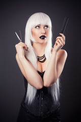 Obraz premium beautiful blonde woman with black make-up and accessories posing