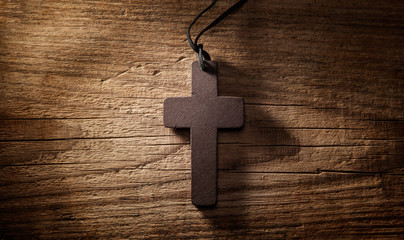 wooden cross on wood background