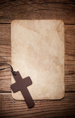 wooden cross on paper background - 76476105