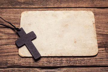 wooden cross on paper background