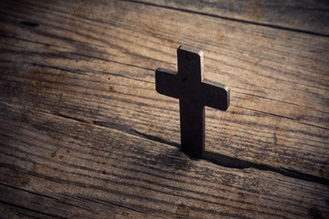 wooden cross on wood background