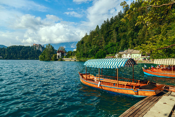 Fototapeta premium Traditional wooden boats Pletna on lake Bled