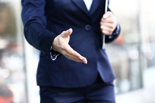 Business Woman With Arm Extended For A Handshake