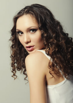 Young fashion model with curly hair