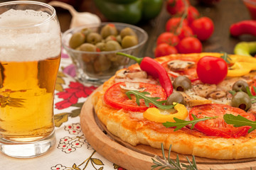 Italian pizza with glass of beer