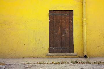 Yellow wall and a wooden door