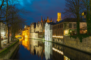 Night cityscape with a tower Belfort and the Green canal in Brug