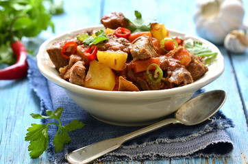 Meat stewed with vegetable in spicy tomato sauce.