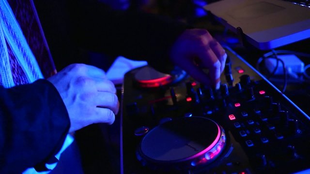 DJ mixes tracks at the disco