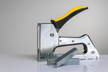 Furniture stapler on white background