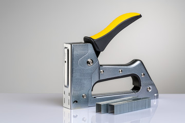 Furniture stapler on white background