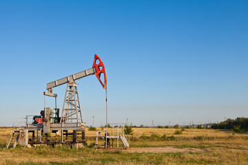 Fototapeta na wymiar Oil pump on a background of blue sky