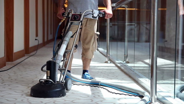 Cleaner Male Worker Cleaning Hotel Corridor Carpet
