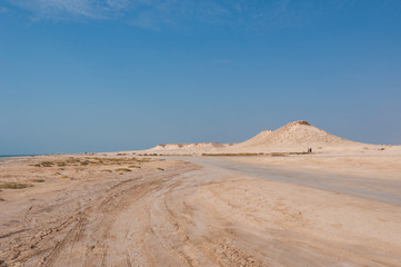 Fototapeta na wymiar Remote empty sand filled desert in Zekreet- Qatar middle east
