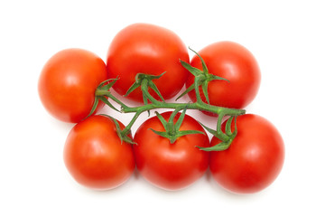 bunch of ripe red tomatoes closeup on a white background