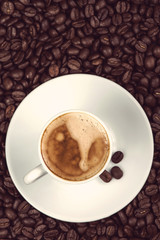 overhead view on cup of expresso coffee  and roasted beans