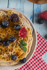 Pancakes with blueberry, raspberry honey and mint