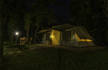 Big tent at night with lantern and lamp
