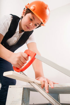 boy sawing board