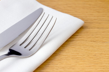 Knife and fork on a white napkin