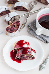 Cherry and walnut strudel on a white table. Selective focus