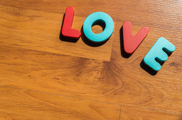 Wooden word LOVE on laminate floor