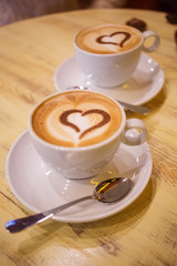 Coffee cup with milk and heart shape